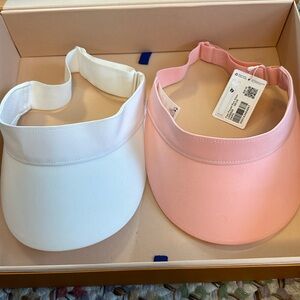 Two lululemon visors 1 white 1 pink. Pink has never been worn